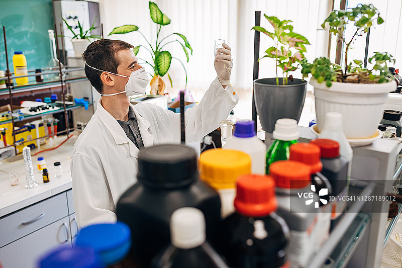 自豪的年轻法医拿着他成功分析的证据图片素材