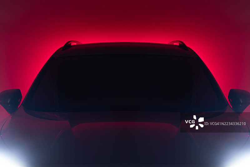 在红色灯光照射下的抽象未来主义轮廓汽车图片素材